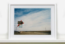 Load image into Gallery viewer, Part of the 'Dream in Colour' series, 'Roy's - Route 66' is one of Richard Heeps' classic American sign artworks featuring the road sign for Roy's Motel, which demonstrates historic Mid-Century Modern Googie architecture. This photograph was capture on the National Trails Highway of U.S. Route 66, in the Mojave Desert town of Amboy in San Bernardino County, California.