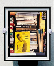 Load image into Gallery viewer, ‘Scientific Sexology’ sits amongst a stack of books, captured in Milan, Italy. 