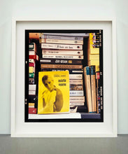 Load image into Gallery viewer, ‘Scientific Sexology’ sits amongst a stack of books, captured in Milan, Italy. 