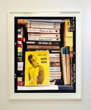 Load image into Gallery viewer, ‘Scientific Sexology’ sits amongst a stack of books, captured in Milan, Italy. 