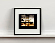 Load image into Gallery viewer, Silhouettes seen through a shop window in Milan. 
