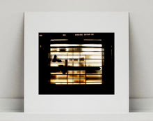 Load image into Gallery viewer, Silhouettes seen through a shop window in Milan. 