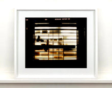 Load image into Gallery viewer, Silhouettes seen through a shop window in Milan. 