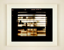 Load image into Gallery viewer, Silhouettes seen through a shop window in Milan. 