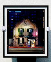 Load image into Gallery viewer, The traditional Italian Tobacconist shop, here in a Swiss Cottage style building set against a vast urban apartment block.