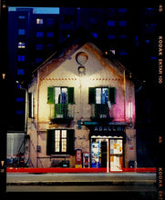 Load image into Gallery viewer, The traditional Italian Tobacconist shop, here in a Swiss Cottage style building set against a vast urban apartment block.