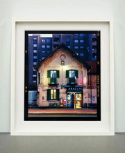 Load image into Gallery viewer, The traditional Italian Tobacconist shop, here in a Swiss Cottage style building set against a vast urban apartment block. 