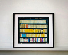 Load image into Gallery viewer, As part of Richard Heeps' series, A Short History of Milan, The Last Kiss features a series of yellow, blue and pink Italian books.