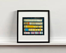 Load image into Gallery viewer, As part of Richard Heeps' series, A Short History of Milan, The Last Kiss features a series of yellow, blue and pink Italian books.