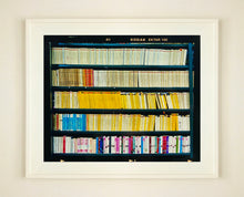 Load image into Gallery viewer, As part of Richard Heeps' series, A Short History of Milan, The Last Kiss features a series of yellow, blue and pink Italian books.