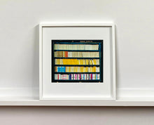 Load image into Gallery viewer, As part of Richard Heeps' series, A Short History of Milan, The Last Kiss features a series of yellow, blue and pink Italian books.