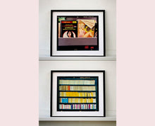 Load image into Gallery viewer, As part of Richard Heeps' series, A Short History of Milan, The Last Kiss features a series of yellow, blue and pink Italian books.