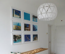 Load image into Gallery viewer, Part of Richard Heeps' 'Dream in Colour' Series, 'Beach Ball' captures Palm Springs mid-century modern architecture behind a trio of pink and black beach balls. The stillness and the subtle colours combine to make a calming artwork with a seductive cinematic vibe.