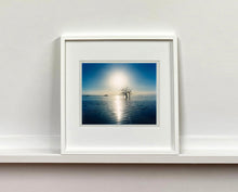 Load image into Gallery viewer, Towards Rock Hill, photographed by Richard in Bombay Beach, Salton Sea, California. The horizon intersected by sun rays, featuring a tree unexpectedly rising out of the lake gives this piece an ethereal quality. 