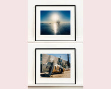 Load image into Gallery viewer, Towards Rock Hill, photographed by Richard in Bombay Beach, Salton Sea, California. The horizon intersected by sun rays, featuring a tree unexpectedly rising out of the lake gives this piece an ethereal quality. 