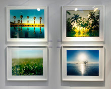 Load image into Gallery viewer, Towards Rock Hill, photographed by Richard in Bombay Beach, Salton Sea, California. The horizon intersected by sun rays, featuring a tree unexpectedly rising out of the lake gives this piece an ethereal quality. 