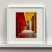 Load image into Gallery viewer, Monte Amiata housing, Gallaratese Quarter, Milan. Red and yellow brutalist architecture street photography by Richard Heeps framed in white.