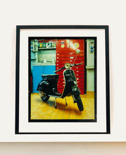 Load image into Gallery viewer, A black vespa against a red, blue and yellow interior. Photographed in Milan, Italy. 