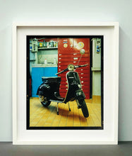 Load image into Gallery viewer, A black vespa against a red, blue and yellow interior. Photographed in Milan, Italy. 