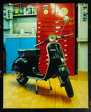 Load image into Gallery viewer, A black vespa against a red, blue and yellow interior. Photographed in Milan, Italy. 