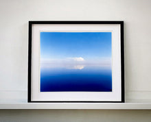 Load image into Gallery viewer, 'View from Bombay Beach' looks over Salton Sea in California. Cooling shades of blue, reflection and symmetry are key to this serene waterscape. The suspended cloud which looks surreal creates a feeling of weightlessness. 
