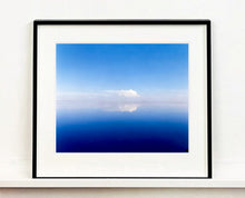 Load image into Gallery viewer, 'View from Bombay Beach' looks over Salton Sea in California. Cooling shades of blue, reflection and symmetry are key to this serene waterscape. The suspended cloud which looks surreal creates a feeling of weightlessness. 