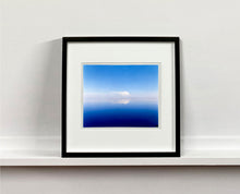 Load image into Gallery viewer, 'View from Bombay Beach' looks over Salton Sea in California. Cooling shades of blue, reflection and symmetry are key to this serene waterscape. The suspended cloud which looks surreal creates a feeling of weightlessness. 
