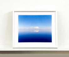 Load image into Gallery viewer, 'View from Bombay Beach' looks over Salton Sea in California. Cooling shades of blue, reflection and symmetry are key to this serene waterscape. The suspended cloud which looks surreal creates a feeling of weightlessness. 