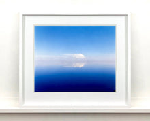 Load image into Gallery viewer, 'View from Bombay Beach' looks over Salton Sea in California. Cooling shades of blue, reflection and symmetry are key to this serene waterscape. The suspended cloud which looks surreal creates a feeling of weightlessness. 