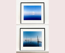 Load image into Gallery viewer, 'View from Bombay Beach' looks over Salton Sea in California. Cooling shades of blue, reflection and symmetry are key to this serene waterscape. The suspended cloud which looks surreal creates a feeling of weightlessness. 