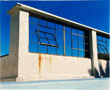 Load image into Gallery viewer, 'Window of the World, Zzyzx Resort Pool', photographed in Soda Dry Lake, California shows window pains and a distressed wall, against a bright blue background of sky. This artwork is part of Richard's 'Dream in Colour' series. 