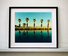 Load image into Gallery viewer, Plam trees stand tall against ombre skies in shades of blue and green in 'Zzyzx Resort Pool II', taken in Soda Dry Lake, California. This artwork was taken on a road trip from LA to Las Vegas. This photograph was taken on negative in 2002 but only executed in Richard's darkroom for the first time in 2017.